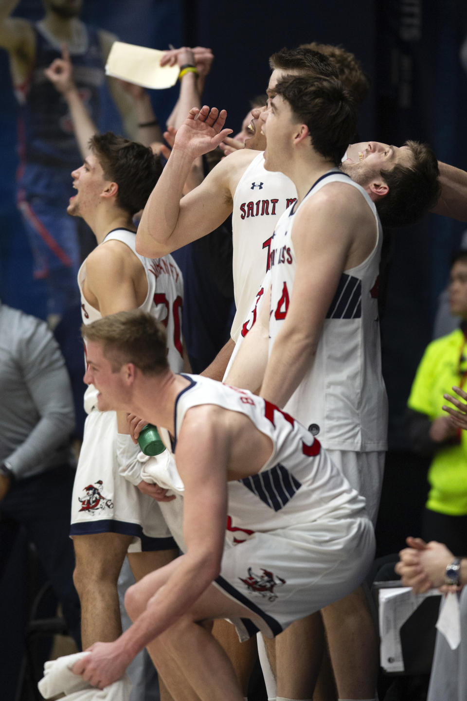 The Saint Mary's bench reacts to a teammate's score against Pepperdine during the second half of an NCAA college basketball game, Thursday, Feb. 15, 2024, in Moraga, Calif. (AP Photo/D. Ross Cameron)