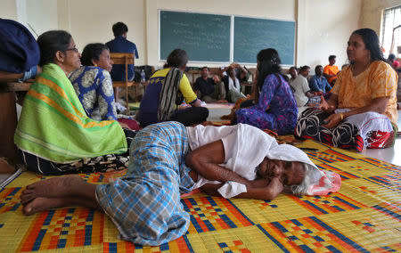 Flood victims rest inside a university classroom, which is converted into a temporary relief camp in Kochi in Kerala, August 18, 2018. REUTERS/Sivaram V