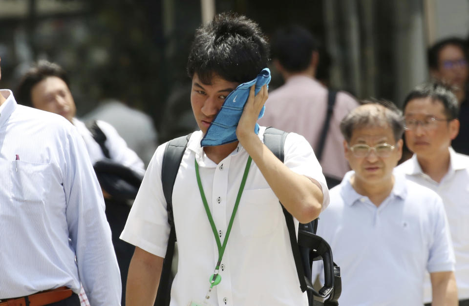 <p>A man wipes the sweat from his face in the scorching heat at a business district in Tokyo, Monday, July 23, 2018. (Photo: Koji Sasahara/AP) </p>