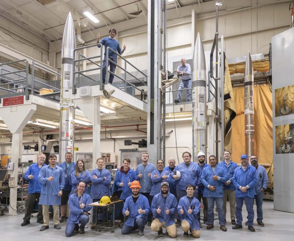 Aroh Barjatya, top left, and other NASA and Embry-Riddle Aeronautical researchers pose with three sounding rockets that will be launched during the April 8 solar eclipse as part of the Atmospheric Perturbations around Eclipse Path mission.