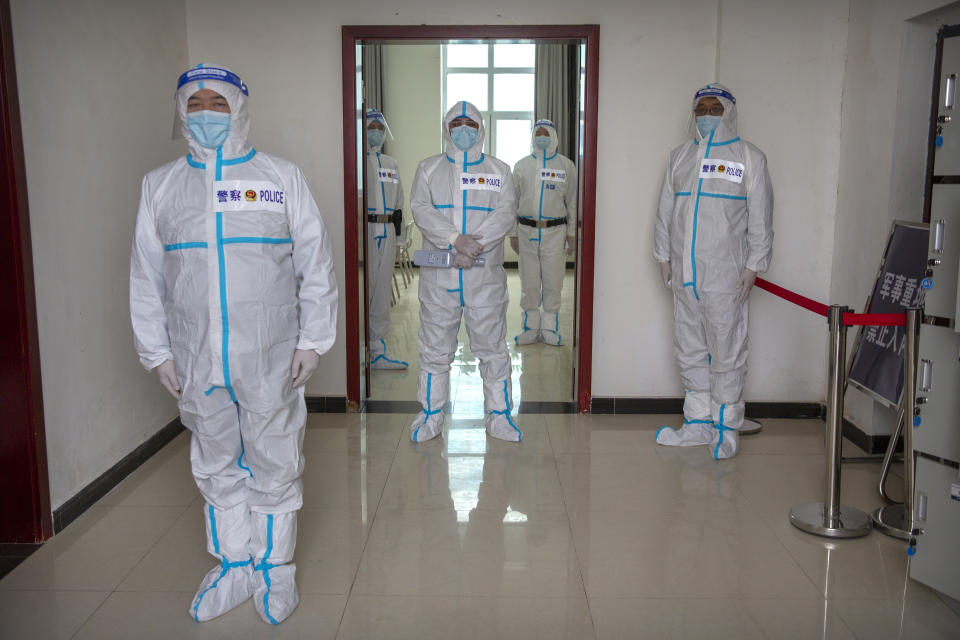 Security officers in protective suits stand near the entrance checkpoint to the inmate detention area at the Urumqi No. 3 Detention Center in Dabancheng in western China's Xinjiang Uyghur Autonomous Region on April 23, 2021. Urumqi No. 3, China's largest detention center, is twice the size of Vatican City and has room for at least 10,000 inmates. (AP Photo/Mark Schiefelbein)