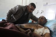 A man who was wounded in a bomb attack lies at a hospital in Baquba, about 50 km (31 miles) northeast of Baghdad, January 15, 2014. Bombs hit Iraq's capital Baghdad and a village near the northern town of Baquba on Wednesday, killing at least 59 people, police and hospital sources said, as Prime Minister Nuri al-Maliki warned that militants were trying to set up an "evil statelet." In the deadliest incident, a bomb blew up in a funeral tent where mourners were marking the death two days ago of a Sunni Muslim pro-government militiaman, police said. It killed 18 people and wounded 16 in Shatub, a village south of Baquba. (REUTERS/Mohammed Adnan)