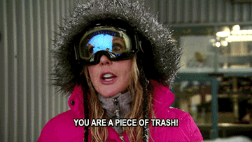 Vicky wearing winter gear, including a parka and ski goggles, with the caption "YOU ARE A PIECE OF TRASH!" at the bottom of the image