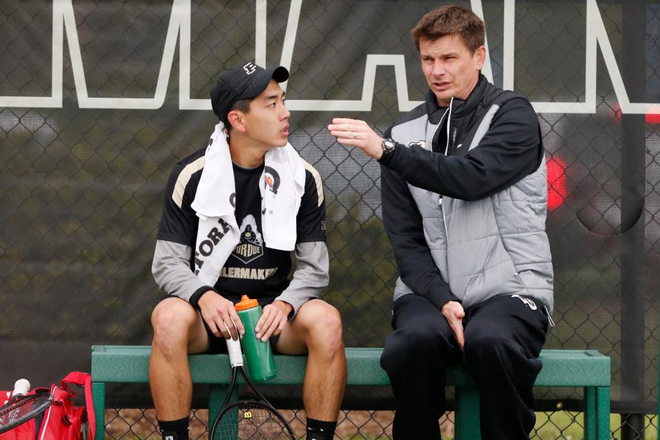 Renan Hanayama listens to Purdue listens to the advice of head coach Pawel Gajdzik between games in his match at No. 5 singles against Chris Dean of Nebraska in the Big Ten tennis tournament Thursday, April 27, 2017, at the Schwartz Tennis Center on the campus of Purdue University. Purdue defeated Nebraska 4-1.