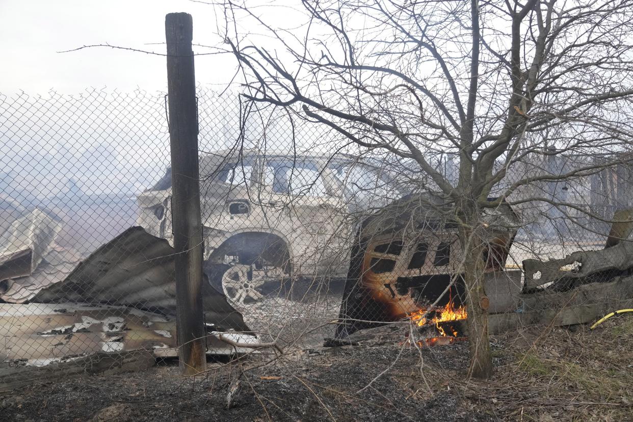 A view of the debris of a house and a burned car in the aftermath of Russian shelling, outside Kyiv, Ukraine, Thursday, Feb. 24, 2022.