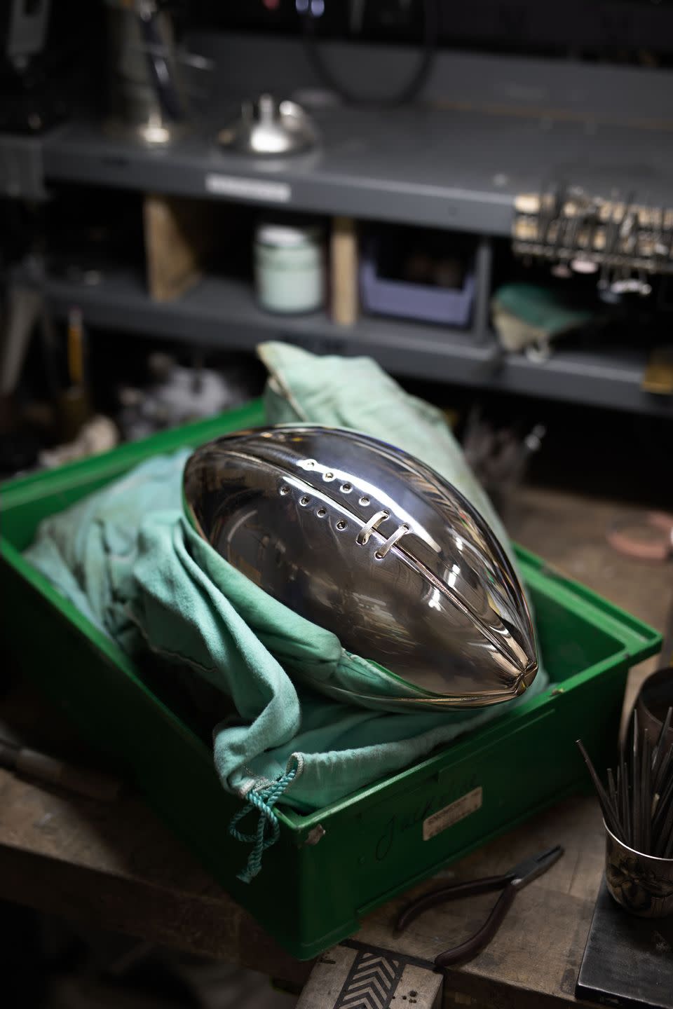 football on top of tiffany super bowl trophy in progress