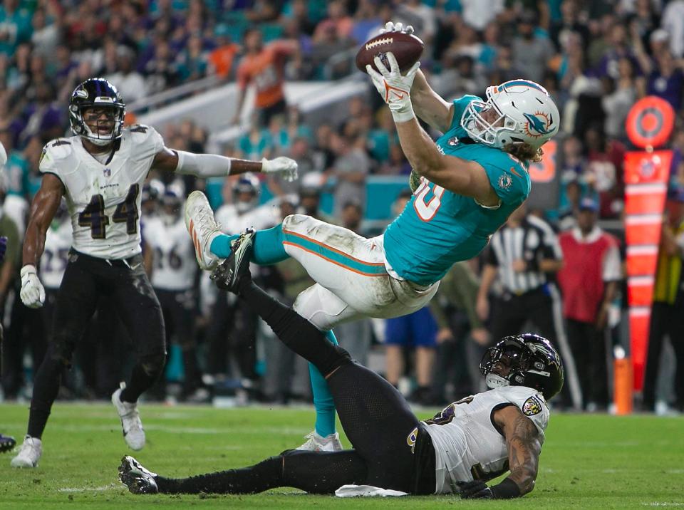 Dolphins tight end Adam Shaheen makes a catch against Ravens safety Chuck Clark during last Thursday's game at Hard Rock Stadium.