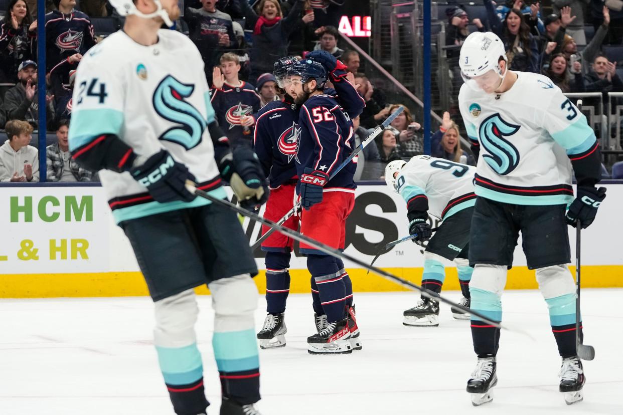 Jan 13, 2024; Columbus, Ohio, USA; Columbus Blue Jackets center Kent Johnson (91) celebrates a goal by right wing Emil Bemstrom (52) during the third period of the NHL hockey game against the Seattle Kraken at Nationwide Arena. The Blue Jackets lost 7-4.