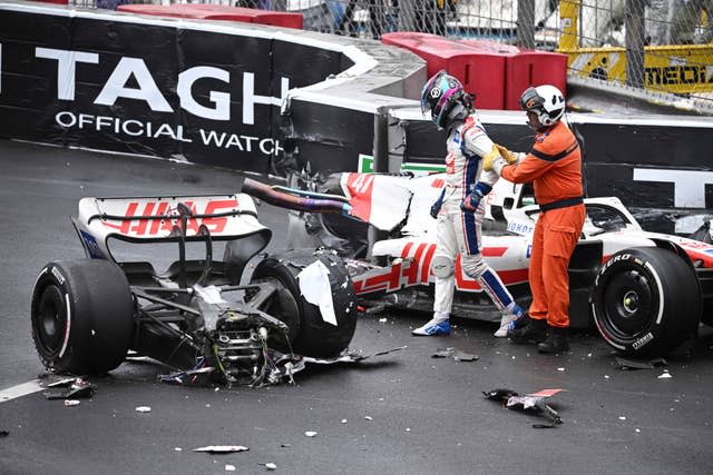 Haas driver Mick Schumacher walks away from his wrecked car after crashing during the Monaco F1 Grand Prix