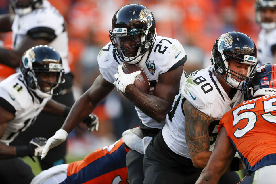 Jacksonville Jaguars running back Leonard Fournette, center, runs with the ball during the second half of an NFL football game against the Denver Broncos, Sunday, Sept. 29, 2019, in Denver. (AP Photo/David Zalubowski)