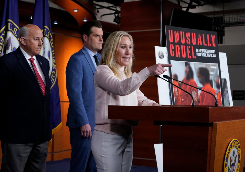 Rep. Marjorie Taylor Greene, R-Ga., joined at left by Rep. Louie Gohmert, R-Texas, and Rep. Matt Gaetz, R-Fla., speaks at a news conference about the treatment of people being held in the District of Columbia jail who are charged with crimes in the Jan. 6 insurrection at the U.S. Capitol.