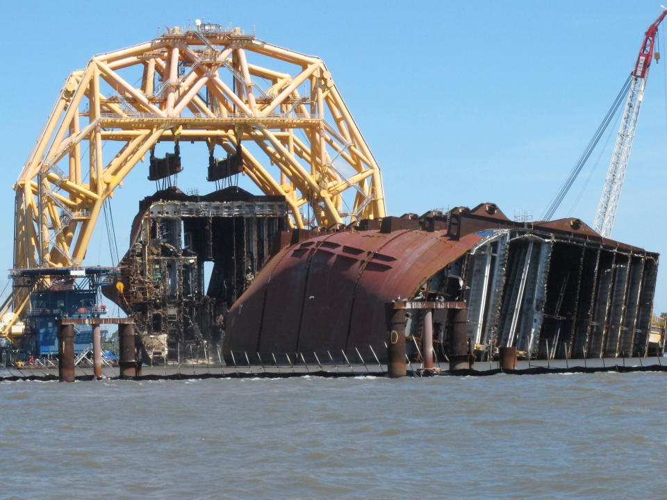 FILE - In this April 26, 2021 file photo, a towering crane pulls the engine room section away from the remains of the capsized cargo ship Golden Ray offshore of St. Simons Island, Ga. Accounts contained in crew member interviews are among more than 1,700 pages of documents made public Thursday, July 29, by the National Transportation Safety Board. The Golden Ray, carrying more than 1,400 vehicles, overturned after leaving the Port of Brunswick along the Georgia coast on Sept. 8, 2019. Tennant and about two dozen crew members on board were rescued and survived. (AP Photo/Russ Bynum, File)