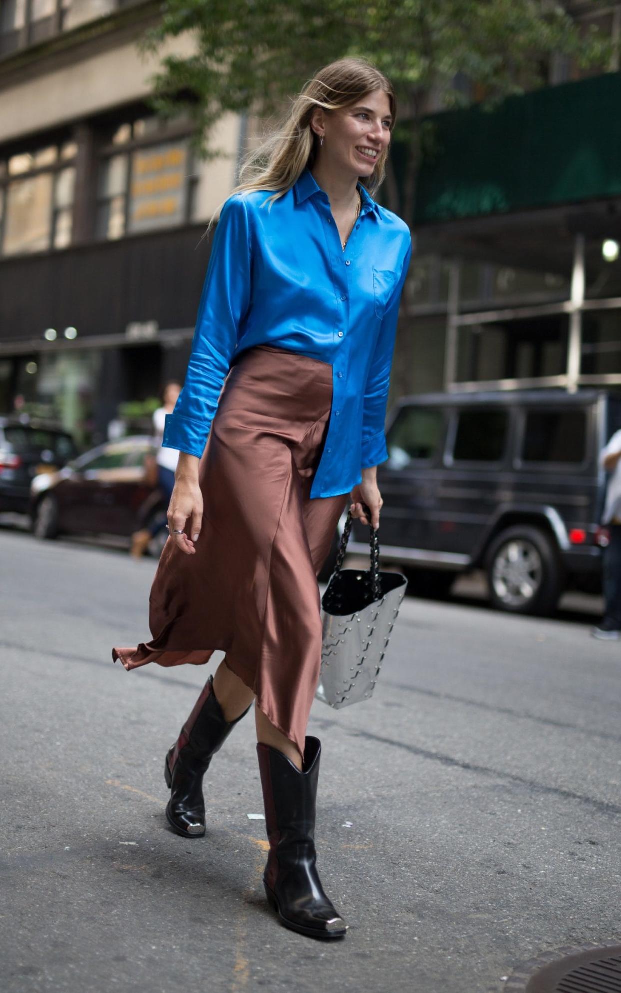 Founder of Hey Woman! Veronika Heilbrunner wears a silk shirt sans jacket while out and about in New York's warm September weather  - Getty Images North America