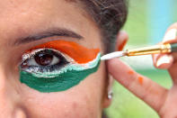 A college girl gets her eye painted in tri-colours of India's national flag on the eve of the country's Independence Day celebrations in the northern Indian city of Chandigarh. REUTERS/Ajay Verma