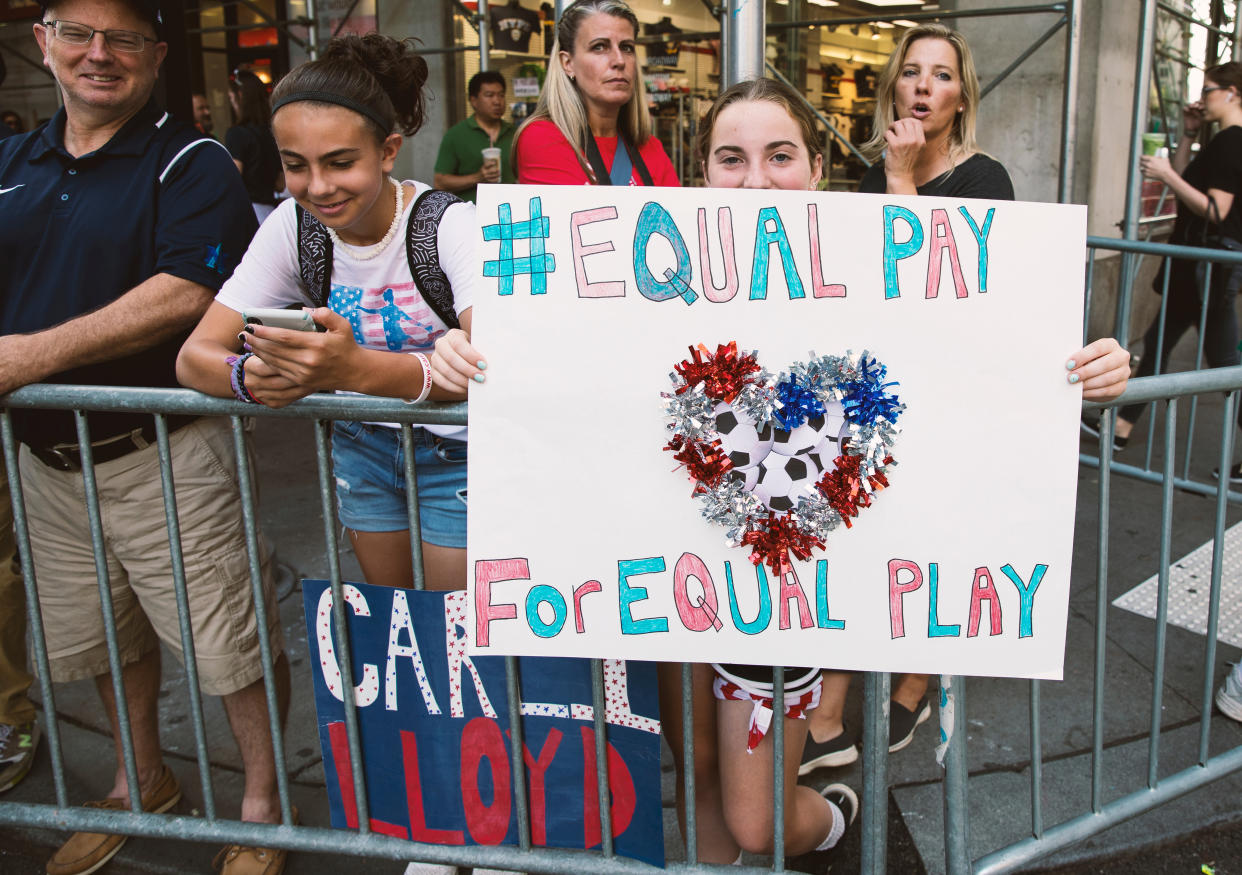 Soccer: USWNT Women's World Cup Parade: Young fan holding up sign that reads EQUAL PAY FOR EQUAL PAY while watching parade going through Canyon of Heroes route. New York, NY 7/10/2019 CREDIT: Taylor Ballantyne (Photo by Taylor Ballantyne /Sports Illustrated/Getty Images) (Set Number: X162758 TK1 )