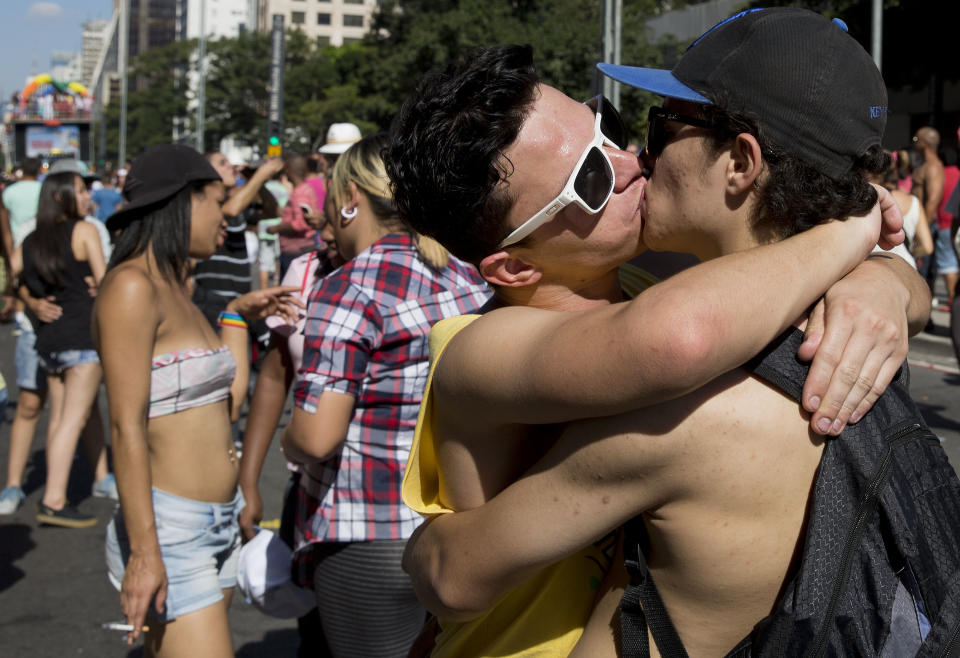 A couple kisses during a Gay Pride Parade in Sao Paulo, Brazil, Sunday, May 4, 2014. Gay rights advocates are calling for a Brazilian law against discrimination as they gather by the hundreds of thousands in Sao Paulo for one of the world's largest gay pride parades. (AP Photo/Andre Penner)