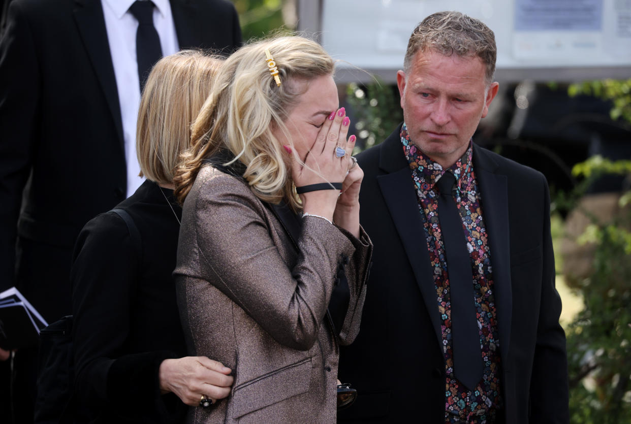 ORPINGTON, ENGLAND - APRIL 20: Wife of Tom Parker, Kelsey Parker (C), reacts as the coffin is carried from St Francis of Assisi church and lowered into a hearse following a funeral service on April 20, 2022 in Orpington, England. British singer Tom Parker, a member of popular boy band The Wanted, died at the age of 33 after being diagnosed with an inoperable brain tumour. (Photo by Dan Kitwood/Getty Images)