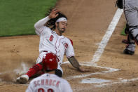 Cincinnati Reds' Jonathan India scores during the fourth inning of the team's baseball game against the Arizona Diamondbacks in Cincinnati, Tuesday, April 20, 2021. (AP Photo/Aaron Doster)