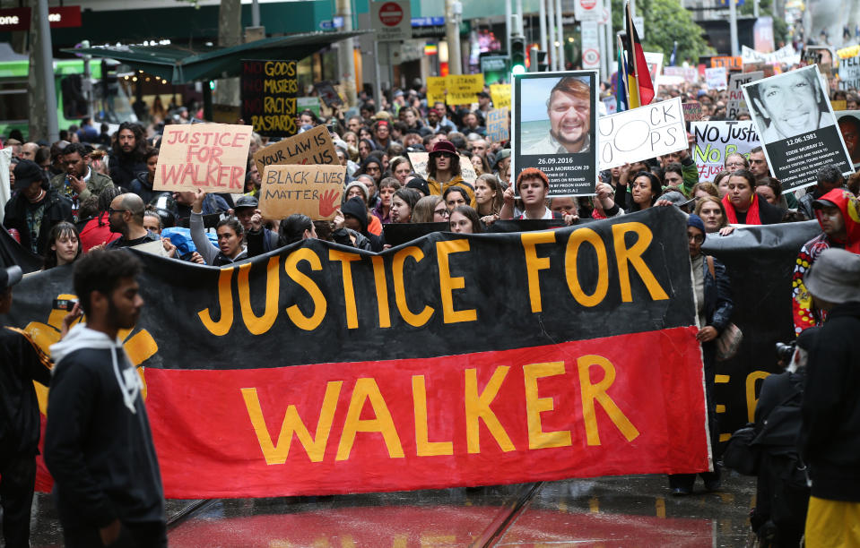 Aboriginal and Torres Strait Islanders communities and allies march during a protest in Melbourne, Wednesday, November 13, 2019. Aboriginal and Torres Strait Islander communities and allies are calling for justice for 19-year-old Warlpiri teenager Kumanjayi Walker, who died after being shot by police on Saturday night in the central desert town of Yuendumu in the Northern Territory. (AAP Image/David Crosling) NO ARCHIVING