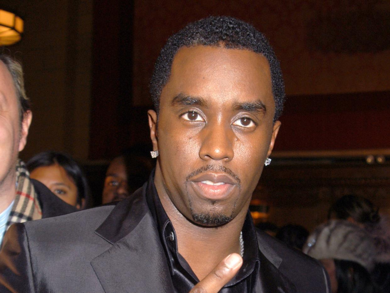 Sean Combs in a black suit and shirt