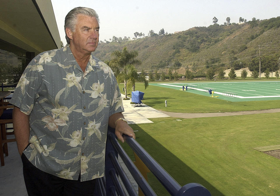 FILE - San Diego Chargers general manager A.J. Smith stares out at the Chargers practice fields from his office balcony, July 9, 2003, in San Diego. Smith, a longtime NFL executive who was the winningest general manager in Chargers history, has died, according to his son on Sunday, May 12, 2024. (AP Photo/Lenny Ignelzi, File)