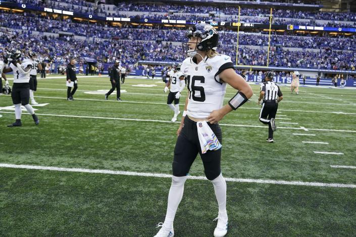 FILE - Jacksonville Jaguars quarterback Trevor Lawrence leaves the field following the team's NFL football game against the Jacksonville Jaguars, Oct. 16, 2022, in Indianapolis. The NFL Players Association is calling on six venues, including Indianapolis, to change their current playing surfaces, saying the turf in those stadiums results in “statistically higher in-game injury rates” involving non-contact and lower-extremity injuries. (AP Photo/Michael Conroy, File)