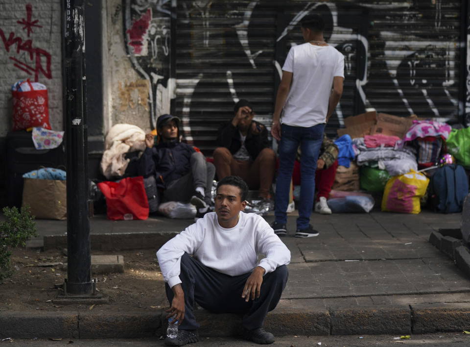 Venezuelan migrants seek assistance outside the Mexican Commission for Refugee Aid in Mexico City, Thursday, Oct. 20, 2022. These Venezuelan migrants were returned to Mexico by U.S. immigration authorities after crossing the border last week. (AP Photo/Fernando Llano)