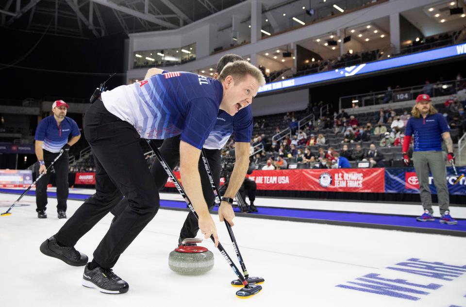 Team Dropkin's Tom Howell, front, and Mark Fenner, obscured, sweep to curl the rock while competing against Team Shuster at the U.S. Olympic Curling Team Trials at Baxter Arena in Omaha, Neb., Wednesday, Nov. 17, 2021. (AP Photo/Rebecca S. Gratz)