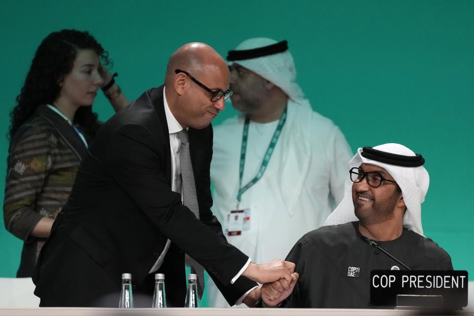 COP28 President Sultan al-Jaber, right, greets United Nations Climate Chief Simon Stiell at a plenary stocktaking session at the COP28 U.N. Climate Summit, Monday, Dec. 11, 2023, in Dubai, United Arab Emirates. (AP Photo/Rafiq Maqbool)