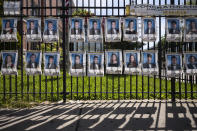 Photographs of the graduating class of 2020 line the fence in front of James Madison High School, Wednesday, May 27, 2020, in the Brooklyn borough of New York. The portraits honor the 750 graduating seniors who may not have the opportunity to step across a graduation stage this year due to the coronavirus pandemic. (AP Photo/Mark Lennihan)