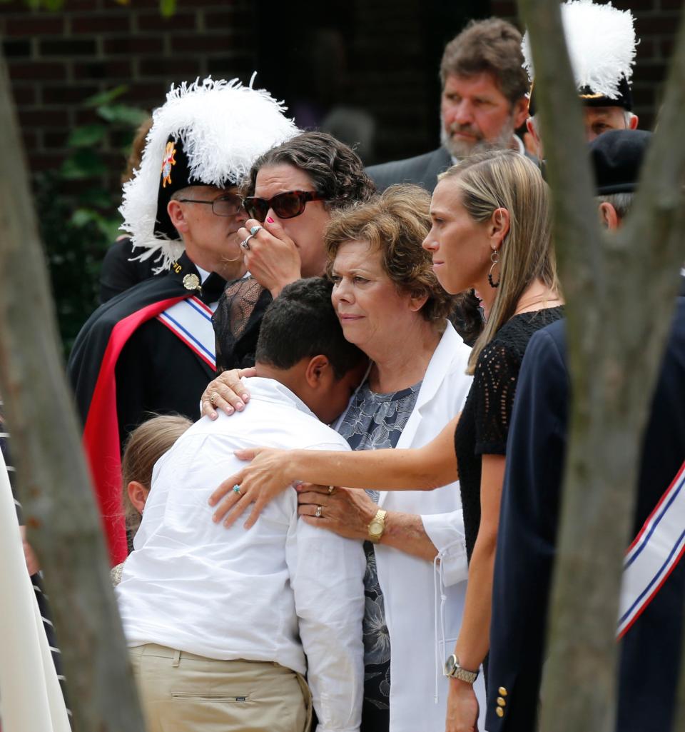 Family and friends watch as the casket of Virginia Beach shooting victim Kate Nixon is wheeled to a hearse after a funeral service at St. Gregory The Great Catholic Church in Virginia Beach , Virginia, on June 6, 2019. Nixon was killed along with 11 others during a mass shooting.