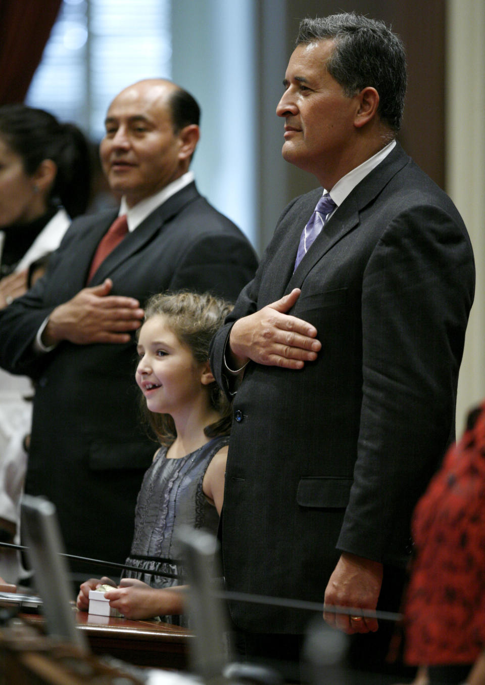 Then-State Sen. Juan Vargas, D-San Diego, right, and his daughter Helena, 7, stand for the Pledge of Alleglance before a swearing in ceremony for Senate members at the Capitol in Sacramento, Calif., on Monday, Dec. 6, 2010. (AP Photo/Steve Yeater) 