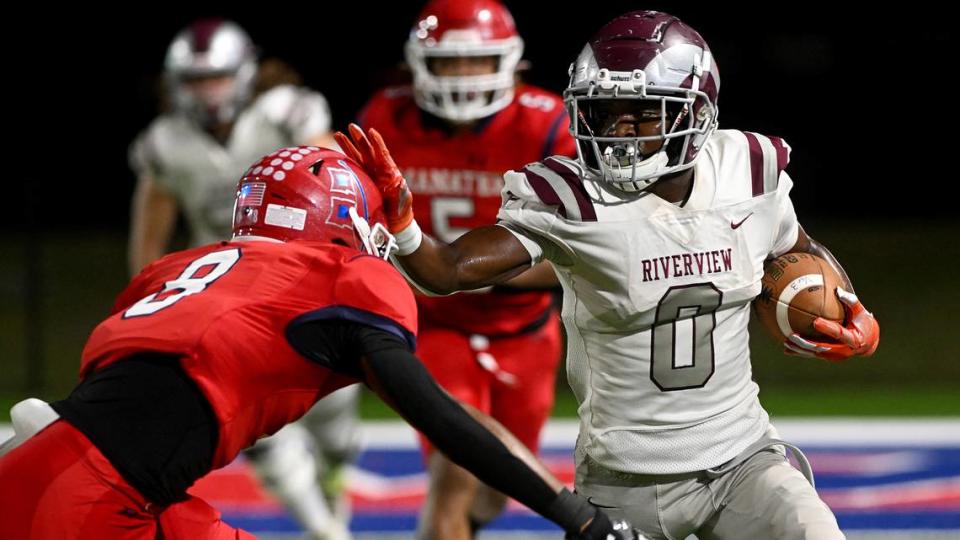 Riverview’s DJ Johnson fends off Manatee’s Raheim Sexil at Joe Kinnan Field at Hawkins Stadium on Friday, Nov. 17, 2023.