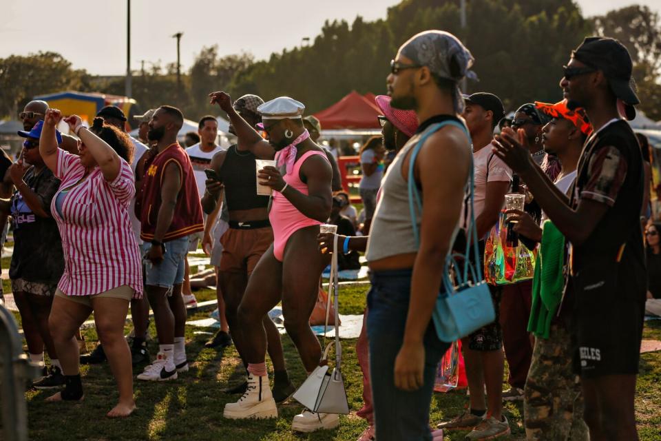 Dr. Matthew Brinkley, center, who is a psychotherapist, jams to the music at South L.A. Pride.