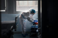 A cleaning worker disinfects a room at the "red zone," an area reserved for treating COVID-19, in the Severo Ochoa Hospital in Leganes on the outskirts of Madrid, Spain, Wednesday, Feb. 17, 2021. (AP Photo/Bernat Armangue)