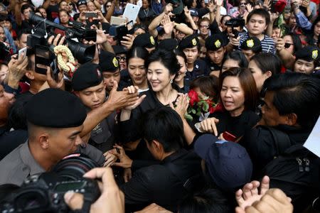 Ousted former Thai prime minister Yingluck greets her supporters as she leaves the Supreme Court in Bangkok, Thailand, July 21, 2017. REUTERS/Athit Perawongmetha