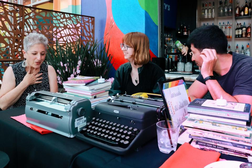 From left, Catherine Gewertz, Syd Shaw and Carlos Allende eat tacos and talk poetry.