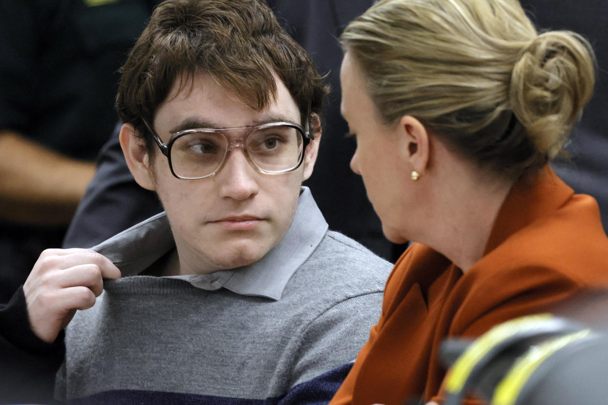 Marjory Stoneman Douglas High School shooter Nikolas Cruz tugs at his shirt collar as he is seated at the defense table for the verdict in his trial at the Broward County Courthouse in Fort Lauderdale, Fla., on Thursday, Oct. 13, 2022. (Amy Beth Bennett/South Florida Sun-Sentinel via AP)