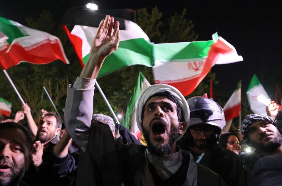 People celebrate the attack on Israel in Tehran (AFP)