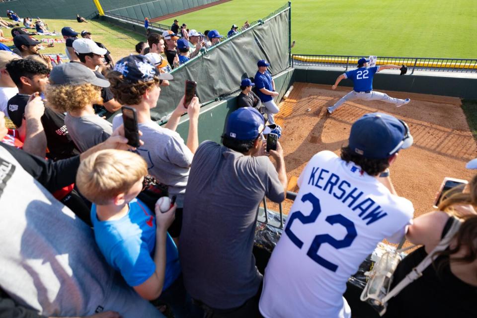 Fans watch Clayton Kershaw warm up for the start of Oklahoma City's rehab in Round Rock, Texas, last Friday.