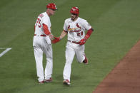 St. Louis Cardinals' Nolan Arenado, right, is congratulated by third base coach Ron 'Pop' Warner after hitting a home run during the third inning of a baseball game against the Pittsburgh Pirates, Friday, June 25, 2021, in St. Louis. (AP Photo/Joe Puetz)
