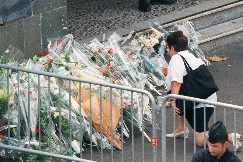 A woman places flowers in front of the Pitie Salpetriere hospital in Paris where Diana was admitted following the fatal crash (AFP via Getty Images)