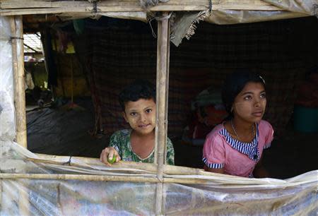 Children look out from their temporary shelter as the government embarks on a national census at a Rohingya refugee camp in Sittwe, the capital of Rakhine State April 1, 2014. REUTERS/Soe Zeya Tun