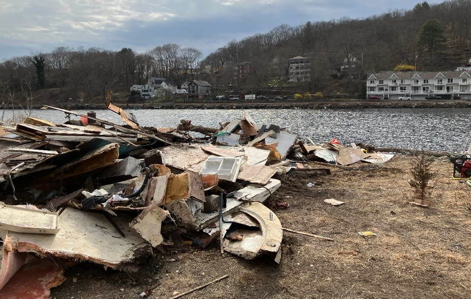 The remains of Tucker Gilbert's houseboat, which crumbled as it was moved from the Thames River after being partially sunken and stuck. The Norwich Fire Department responded to the scene Thursday after people near New Wharf Road smelled gas fumes.