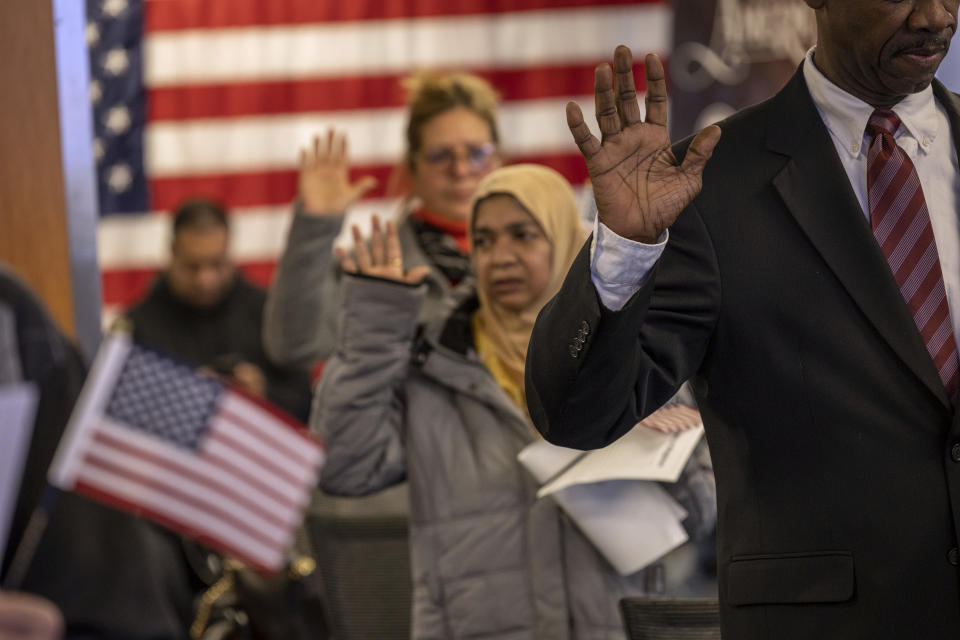 Immigrants take the oath of allegiance during a U.S. Citizenship and Immigration Services naturalization ceremony on February 1, 2023 in Newark, NJ. (Photo by John Moore/Getty)