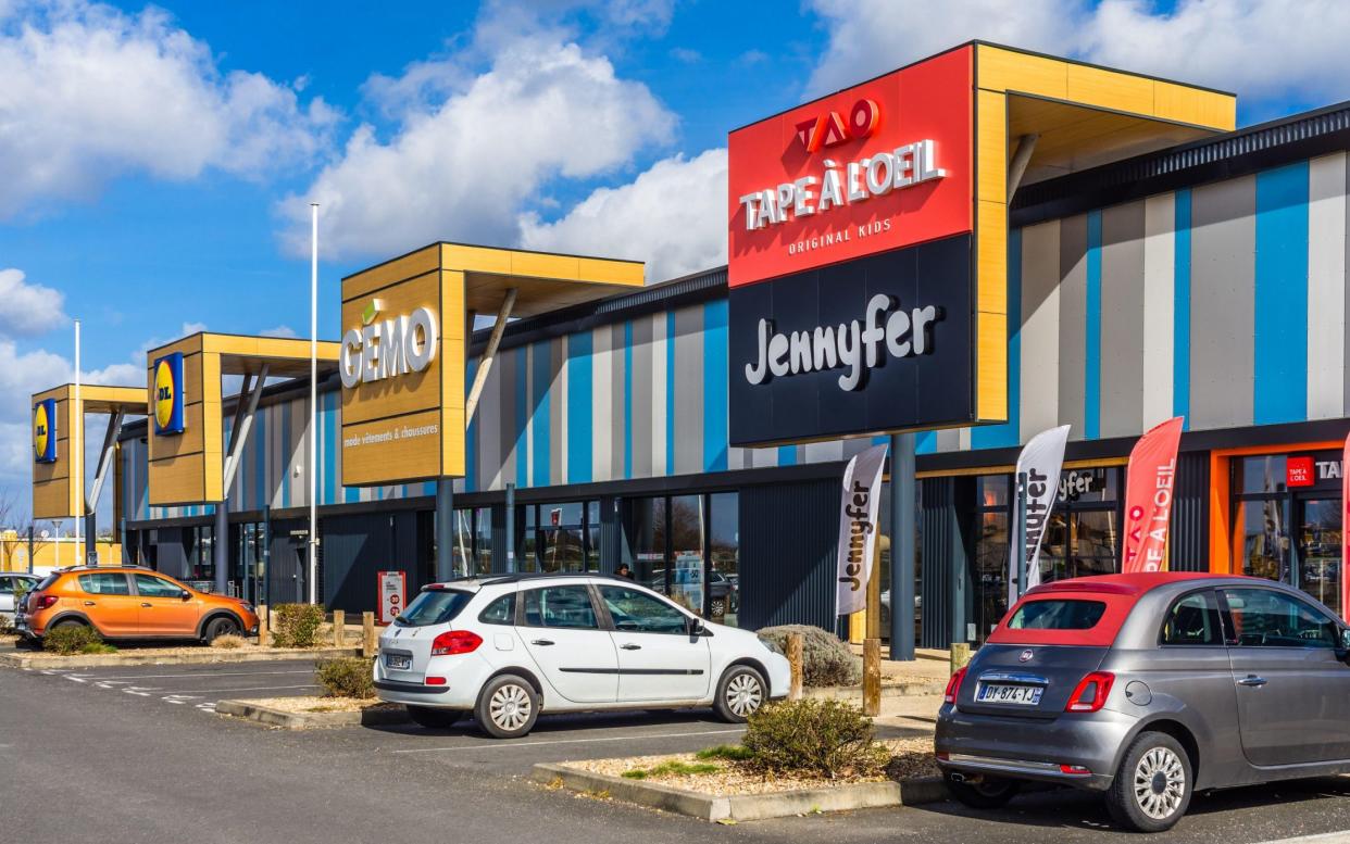 Commercial trading estate displaying corporate signage above store entrances