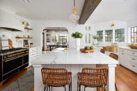 <p> Centering the kitchen at the centre of an open-concept space can create a coherent look across your home &#x2013;&#xA0;especially if you align your farmhouse kitchen ideas with the decor in the adjacent room. Open-plan kitchen ideas also bring a relaxed aesthetic that suits today&apos;s homes and lifestyle. </p> <p> &apos;In this project, rethinking the modern farmhouse style was about getting away from the trendy, expected black and oak look,&apos; explain Lina Galvao and Erin Coren from Curated Nest Interiors.&#xA0; </p> <p> &apos;The colors in the family room &#x2013; black, cream, and blue, with natural wood accents &#x2013; prove to be more vibrant than in your typical farmhouse, but don&apos;t assault the senses. This works particularly well in the home&#x2019;s open-plan setting, where a &quot;light and airy&quot; feeling is emphasized throughout the ground floor space with the repeated use of pale greys, whites, and light woods. </p>