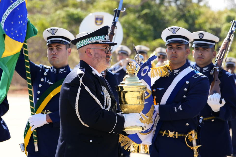 A Portuguese military officer carries a reliquary with the heart of Brazil's former emperor Dom Pedro I as it is given a military honors ceremony at the air base in Brasilia, Brazil, Monday, Aug. 22, 2022. The heart arrived for display during the celebrations of Brazil's bicentennial on Sept. 7. (AP Photo/Eraldo Peres)