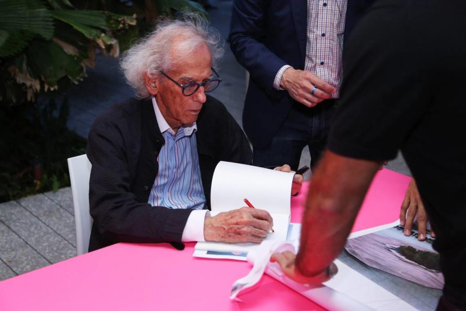 Christo signs books at the opening of the show at Perez Art Museum Miami commemorating the 1983 installation “Surrounded Islands.”