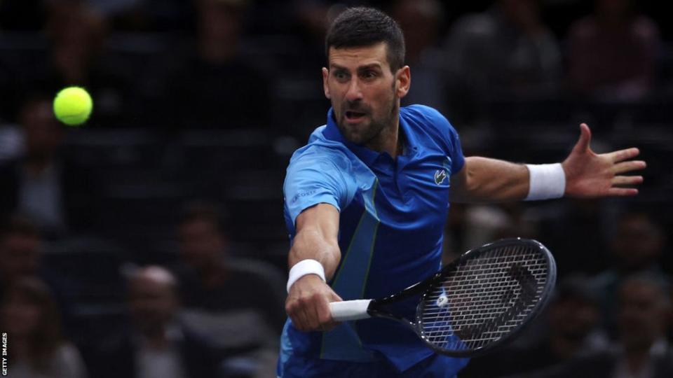 Novak Djokovic of Serbia returns a backhand in his quarter final match against Holger Rune